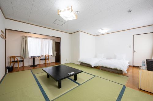 a room with a bed and a table in it at Seaside house & Terrace SEAGULL - Vacation STAY 48168v in Towa