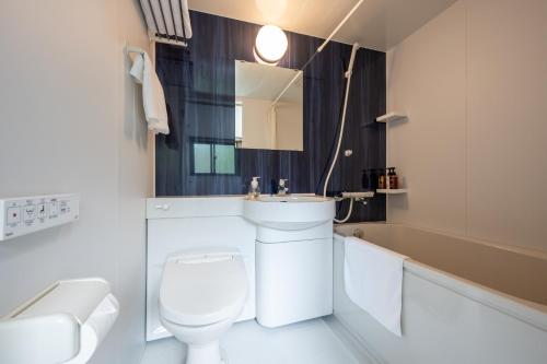 a white bathroom with a toilet and a sink at Seaside house & Terrace SEAGULL - Vacation STAY 48168v in Towa
