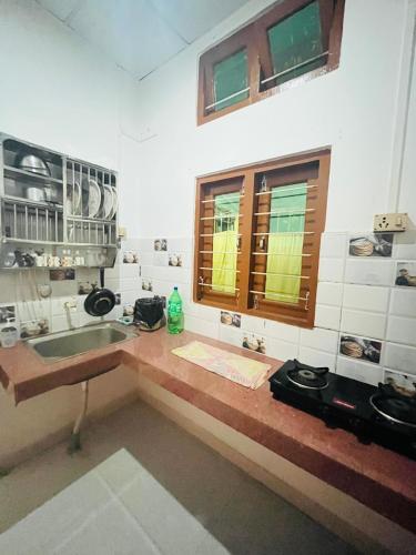 a bathroom with a sink and a window at Debox heaven Homestay in Jorhat