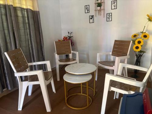 a group of chairs and a table and a table and chairs at Debox heaven Homestay in Jorhat
