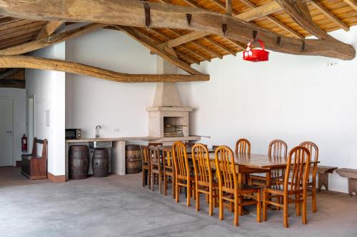 a dining room with a wooden table and chairs at Casa Da Brêa Viana do Castelo - Villa & Apartment in Viana do Castelo