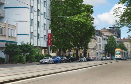 a street with cars parked on the side of the road at Leonardo Hotel Heidelberg City Center in Heidelberg