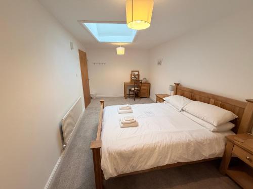 a bedroom with a bed with two towels on it at Low Haven in Keswick