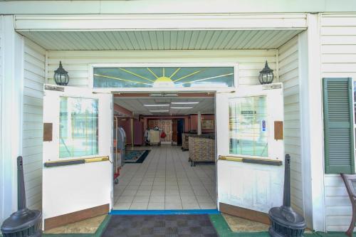 an open door of a building with a hallway at Plantation Inn & Suites Near Locust Grove I 75 in Jackson