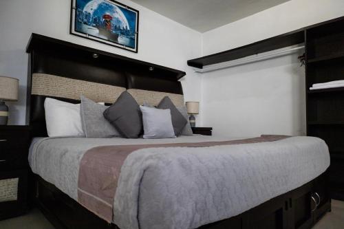 a bedroom with a large bed with a large headboard at HOTEL LAS FUENTES in Tepotzotlán