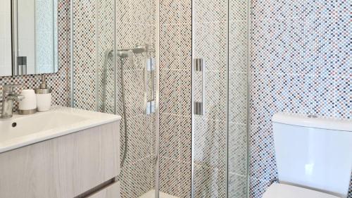 a bathroom with a shower and a toilet and a sink at Porto Plage de Matosinhos in Matosinhos
