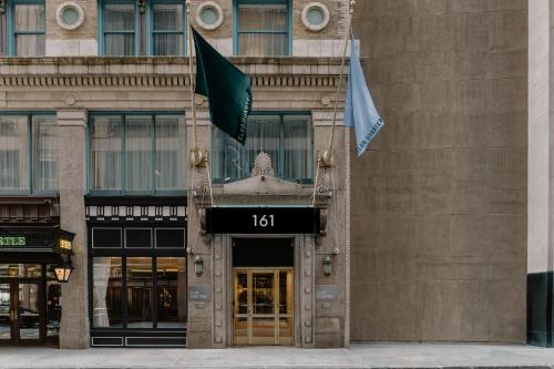 a building with two flags in front of it at Club Quarters Hotel Faneuil Hall, Boston in Boston