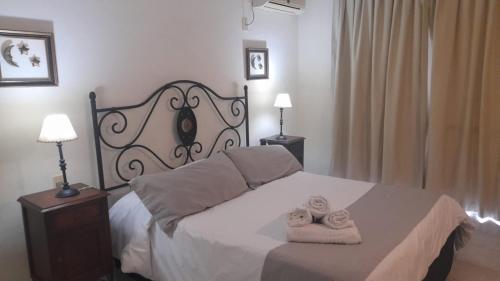 a bedroom with a bed with two towels on it at Solanas Termas de Dayman in Termas del Daymán
