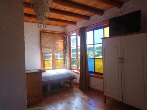 a room with a bed and a large window at Posada la Piedra in Constitución