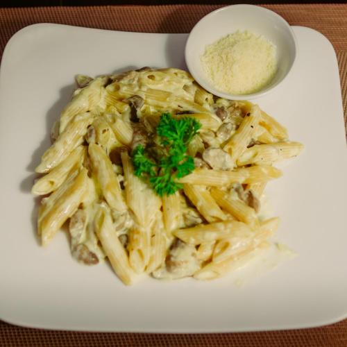 a plate of pasta with parsley on top of it at Chu Hotel in Da Nang