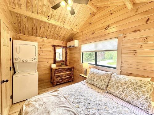 a bedroom with a bed in a wooden cabin at Cozy Coastal Cabin 5 in Steuben