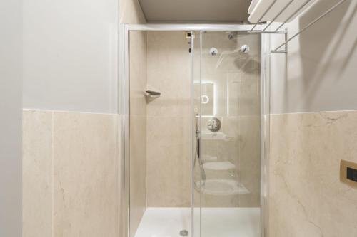 a shower with a glass door in a bathroom at Baires Guest House 2 in Milan