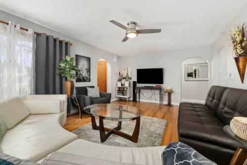 a living room with a couch and a table at Spacious Family Home with Garage Game Room and Office! in Boise