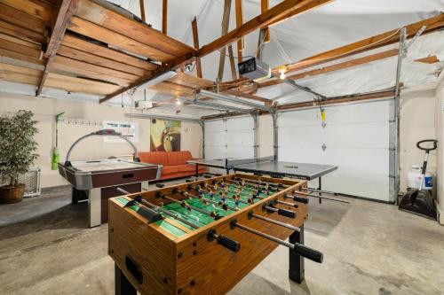 a ping pong table in a room with a pool table at Spacious Family Home with Garage Game Room and Office! in Boise