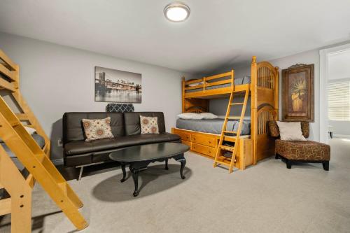 a bedroom with a bunk bed and a couch at Spacious Family Home with Garage Game Room and Office! in Boise