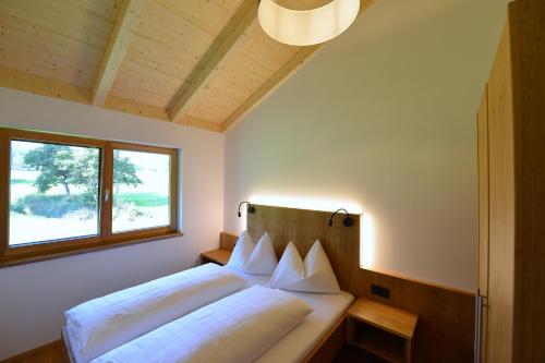 a bedroom with a bed and a window at Ferienhaus Strohschneider in Hermagor