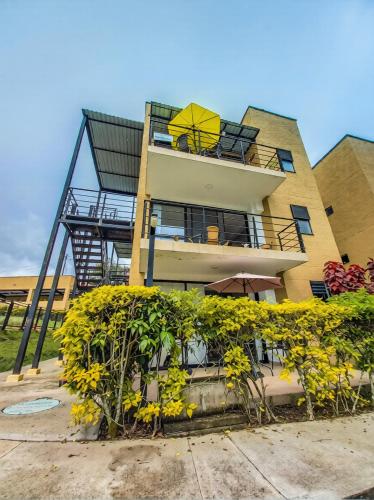 a tall building with a balcony with a balcony at Apartamento turistico diana in La Tebaida