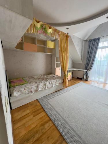a bedroom with a bed and a rug at Villa Trypill in Tripolʼye