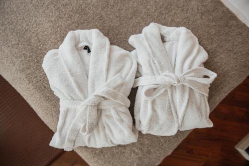 two towels are sitting on the floor at Home Hotel Temperance in Malmö