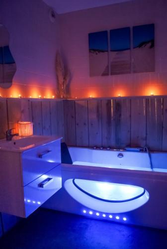 a large bathroom with a tub with lights in it at Le Havre Familial - 5 couchages climatisé in Romans-sur-Isère
