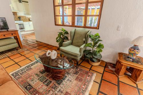 a living room with a chair and a table at Casa Hidalgo Hideaway in Chapala