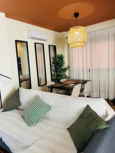 a bedroom with a bed and a dining room at La Escapada in El Ronquillo