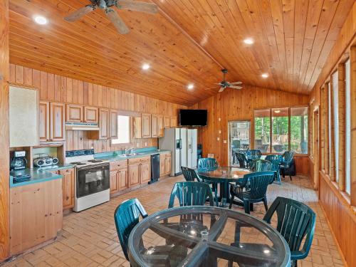 a kitchen with a table and chairs in a room at Clear Creek Escape - Double Decker Dock, New Green Fishing Lights! in Jasper