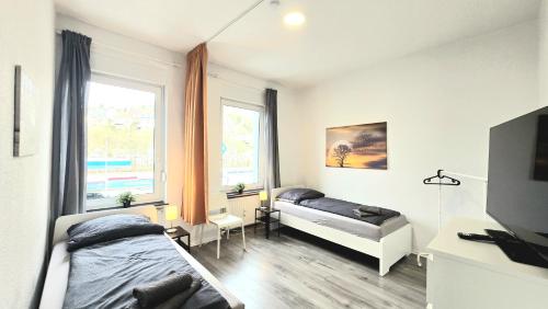 a bedroom with two beds and a window at TOP Monteurwohnung! Modernes Apartment mit Einzelbetten & WLAN & kostenlosen Parkplätzen & voll ausgestattet in Altena - ALT 01 und 02 in Altena