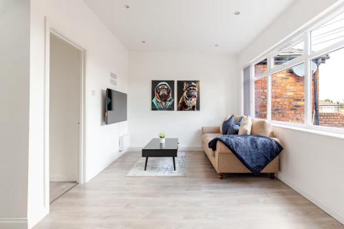 a white living room with a couch and a window at Stylish 2 Bedroom Apartment in Liverpool - Gateacre Village - Free Parking in Liverpool
