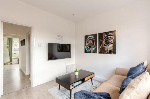 a living room with a couch and a table at Stylish 2 Bedroom Apartment in Liverpool - Gateacre Village - Free Parking in Liverpool