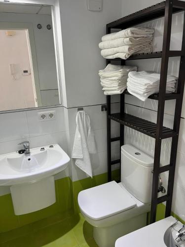 a bathroom with a sink and a toilet and a mirror at over the sea in El Morche