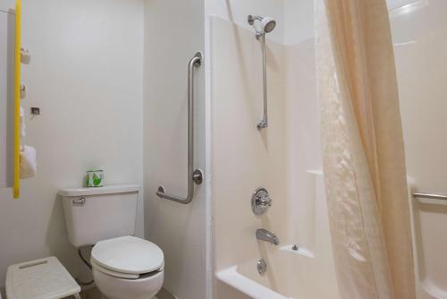 a white bathroom with a toilet and a shower at Motel 6-Marshalltown, IA in Marshalltown
