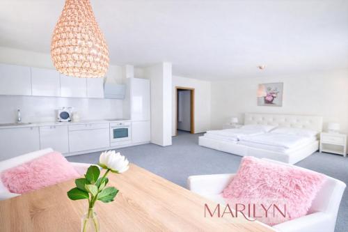 a living room with a dining table and a kitchen at The Meetinka - Peaceful Stay, Jeseníky in Jeseník