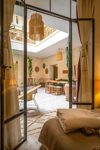 a living room with a glass door leading into a room at Medina Sun in Marrakesh