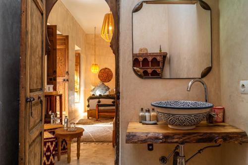 a bathroom with a sink and a mirror at Medina Sun in Marrakesh