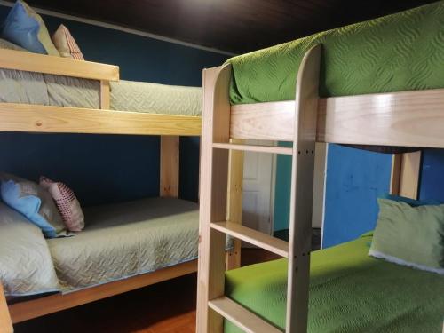 two bunk beds in a room with at Casa Lo Herrera in Isla de Maipo