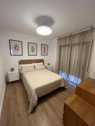 a bedroom with a bed and a large window at Diplomatic Salou in Salou