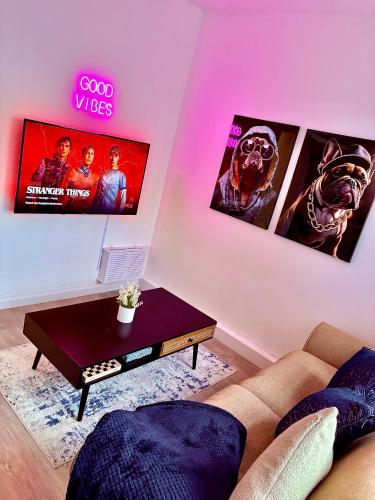 a living room with a couch and a table at Stylish 2 Bedroom Apartment in Liverpool - Gateacre Village - Free Parking in Liverpool