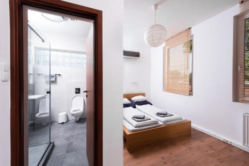 a bedroom with a bed and a bathroom with a toilet at Zora's apartment in Siófok