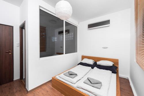 a bedroom with a bed and a mirror at Zora's apartment in Siófok