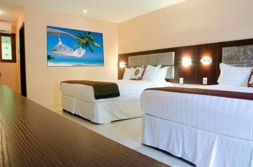 Postel nebo postele na pokoji v ubytování Grand Diamond Hotel Trinidad