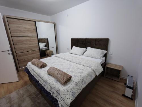 a bedroom with a large bed and a mirror at Stan na dan Bor in Bor