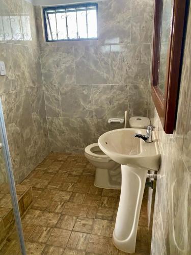 a bathroom with a sink and a toilet at Hotel Arcoiris Mesa de los Santos in Los Santos