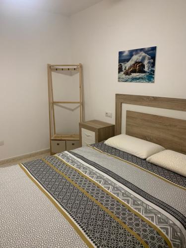 a bedroom with a bed and a ladder in it at Casa Pera Ático duplex 1ª in Chilches