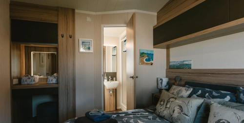 a bedroom with a bed with a wooden headboard at Serenity in Saint Erth