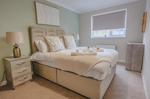 a bedroom with a large bed with towels on it at Dunward House in Livingston