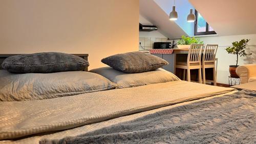 two pillows on top of two beds in a room at Samobor Old Town Studio by the River in Samobor