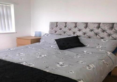 a bedroom with a bed with a gray headboard at Chalet 147 South Shore Bridlington in Bessingby
