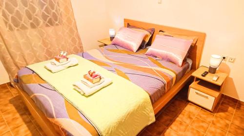 a bedroom with a bed with two towels on it at Sea view house II in Dhílesi