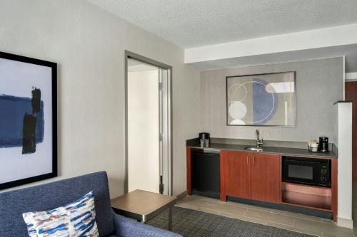 a living room with a couch and a sink at Courtyard Hamilton in Hamilton